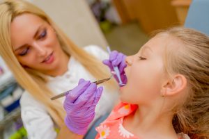 little girl at the dentist PPBEGRW 300x200 - Building a Routine Promotes Good Oral Health