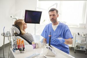 male dentist doing him work in dentists clinic  300x200 - Confused About Insurance Coverage? We Can Help!